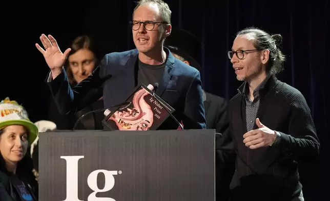 The Ig Nobel Prize for psychology is accepted by Marcin Zajenkowski, left, and Gilles Gignac, for investigating what happens when you tell narcissists — or anyone else — that they are intelligent, Thursday, Sept. 18, 2025, in Boston. (AP Photo/Robert F. Bukaty)