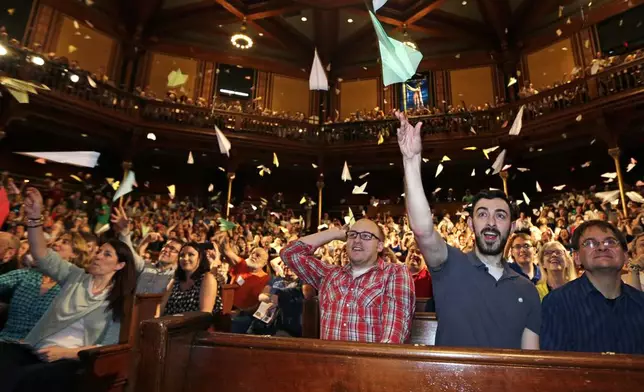 FILE - Audience members launch paper airplanes during a performance at the Ig Nobel Prize ceremony, in Cambridge, Mass., Thursday, Sept. 17, 2015. The Ig Nobel prize is an award handed out by the Annals of Improbable Research magazine for silly sounding scientific discoveries that often have surprisingly practical applications. (AP Photo/Charles Krupa, File)