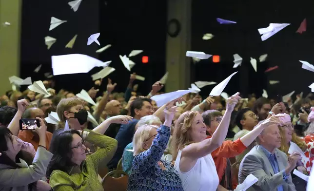 Audience members toss paper airplanes during the Ig Nobel Prize award ceremony, Thursday, Sept. 18, 2025, in Boston. (AP Photo/Robert F. Bukaty)