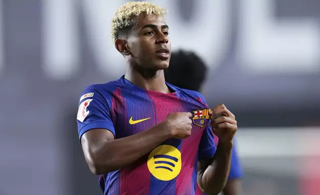 Barcelona's Lamine Yamal celebrates after scoring the opening goal from the penalty spot during the Spanish La Liga soccer match between Rayo Vallecano and FC Barcelona at the Vallecas stadium in Madrid, Spain, Sunday, Aug. 31, 2025. (AP Photo/Manu Fernandez)