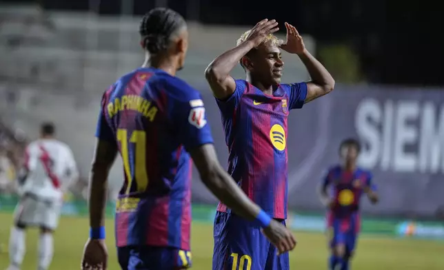 Barcelona's Lamine Yamal celebrates after scoring the opening goal from the penalty spot during the Spanish La Liga soccer match between Rayo Vallecano and FC Barcelona at the Vallecas stadium in Madrid, Spain, Sunday, Aug. 31, 2025. (AP Photo/Manu Fernandez)