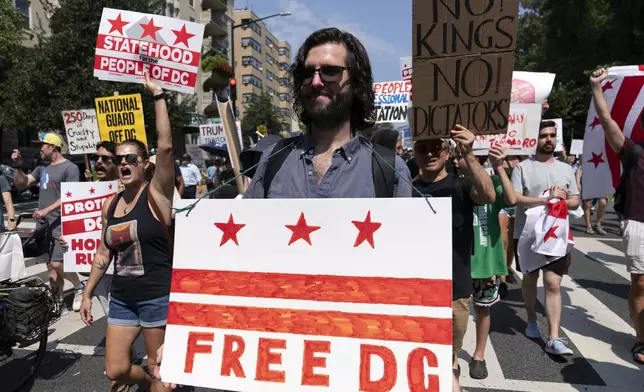 Demonstrators protest against President Donald Trump's deployment of federal law enforcement and National Guard troops in Washington during a march on Saturday, Sept. 6, 2025. (AP Photo/Jose Luis Magana)