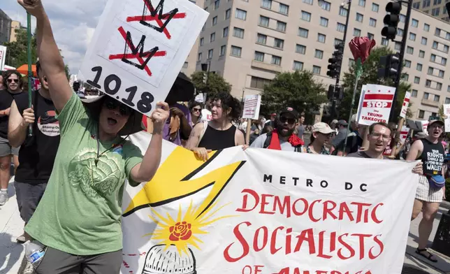 Demonstrators protest against President Donald Trump's deployment of federal law enforcement and National Guard troops in Washington during a march on Saturday, Sept. 6, 2025. (AP Photo/Jose Luis Magana)