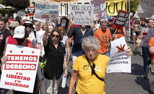 Demonstrators protest against President Donald Trump's deployment of federal law enforcement and National Guard troops in Washington during a march on Saturday, Sept. 6, 2025. (AP Photo/Jose Luis Magana)