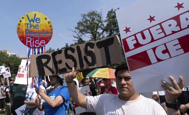 Demonstrators protest against President Donald Trump's deployment of federal law enforcement and National Guard troops in Washington during a march on Saturday, Sept. 6, 2025. (AP Photo/Jose Luis Magana)