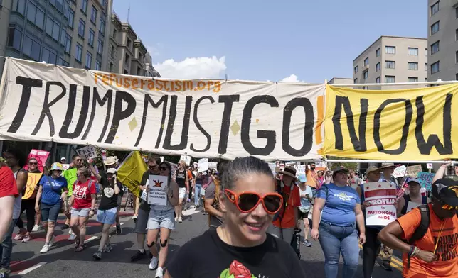 Demonstrators protest against President Donald Trump's deployment of federal law enforcement and National Guard troops in Washington during a march on Saturday, Sept. 6, 2025. (AP Photo/Jose Luis Magana)