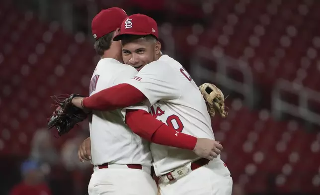 St. Louis Cardinals' Willson Contreras, right, celebrates a victory over the Athletics with teammate Nolan Gorman following a baseball game Wednesday, Sept. 3, 2025, in St. Louis. (AP Photo/Jeff Roberson)