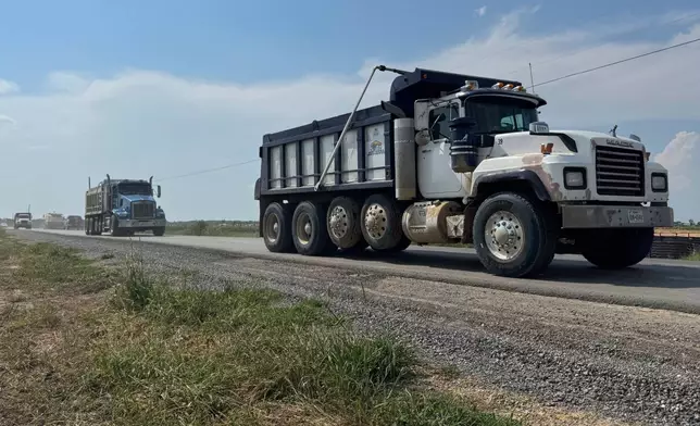 Trucks pass by the site of Meta's Richland Parish Data Center in Holly Ridge, La., Monday, Aug. 18, 2025. (AP Photo/Sophie Bates)