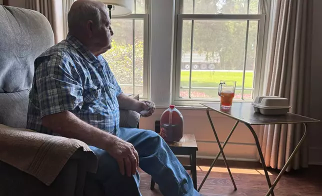 Buddy McCartney watches hundreds of trucks pass by his home in Holly Ridge, La., on their way to what will become Meta's largest data center, Monday, Aug. 18, 2025. (AP Photo/Sophie Bates)
