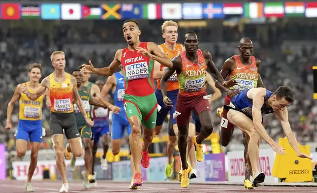 Portugal's Isaac Nader celebrates after winning the gold medal ahead of Britain's Jake Wightman in the men's 1,500 meters final at the World Athletics Championships in Tokyo, Wednesday, Sept. 17, 2025. (AP Photo/Petr David Josek)