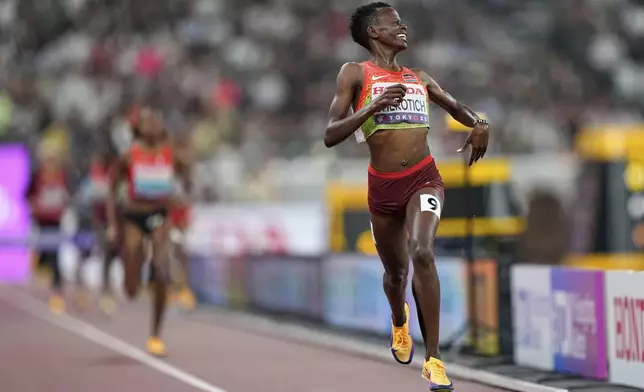 Kenya's Faith Cherotich celebrates after taking gold in the women's 3,000 meters steeplechase final at the World Athletics Championships in Tokyo, Wednesday, Sept. 17, 2025. (AP Photo/Petr David Josek)