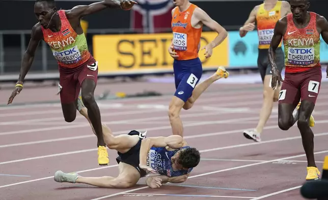 Britain's Jake Wightman falls at the finish line of the the men's 1,500 meters final at the World Athletics Championships in Tokyo, Wednesday, Sept. 17, 2025. (AP Photo/Ashley Landis)