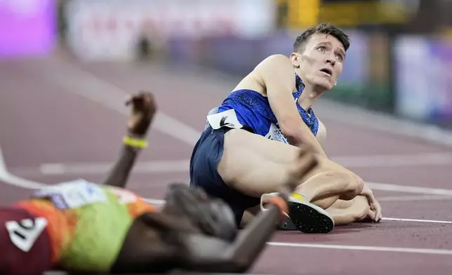 Britain's Jake Wightman sits on the track after taking silver in the men's 1,500 meters final at the World Athletics Championships in Tokyo, Wednesday, Sept. 17, 2025. (AP Photo/Hiro Komae)