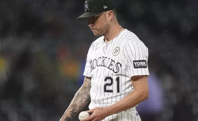 Colorado Rockies starting pitcher Kyle Freeland waits to be pulled from the mound after giving up an RBI double to Miami Marlins' Javier Sanoja in the sixth inning of a baseball game Tuesday, Sept. 16, 2025, in Denver. (AP Photo/David Zalubowski)