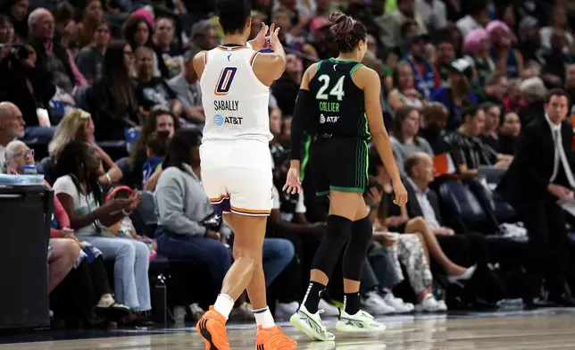 Phoenix Mercury forward Satou Sabally (0) celebrates her 3-point basket towards Minnesota Lynx forward Napheesa Collier (24) during the second half of Game 2 of a WNBA basketball playoff semifinals series Tuesday, Sept. 23, 2025, in Minneapolis. (AP Photo/Matt Krohn)