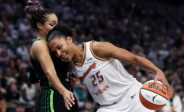 Phoenix Mercury forward Alyssa Thomas, right, drives toward the basket as Minnesota Lynx forward Napheesa Collier defends during the first half of Game 2 of a WNBA basketball playoff semifinals series Tuesday, Sept. 23, 2025, in Minneapolis. (AP Photo/Matt Krohn)