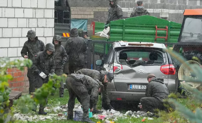 FILE - Territorial defense officers clear debris from a house near Lublin, Poland, after Russian drones violated Polish airspace Thursday, Sept. 11, 2025. (AP Photo/Czarek Sokolowski, File)
