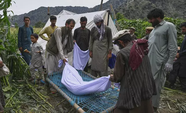 The body of a girl is placed on a bed frame after being pulled from the rubble following Sunday night's powerful 6.0-magnitude earthquake, in a remote area of Kunar province, Afghanistan, Tuesday, Sept. 2, 2025, (AP Photo/Nava Jamshidi)