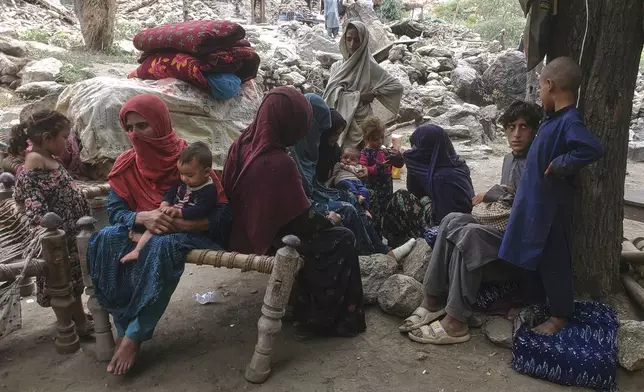 Displaced Afghan families gather under trees with their belongings after a powerful earthquake destroyed their homes in eastern Afghanistan on Sunday, in Mazar Dara, Kunar province, Wednesday, Sept. 3, 2025. (AP Photo/Hedayat Shah)