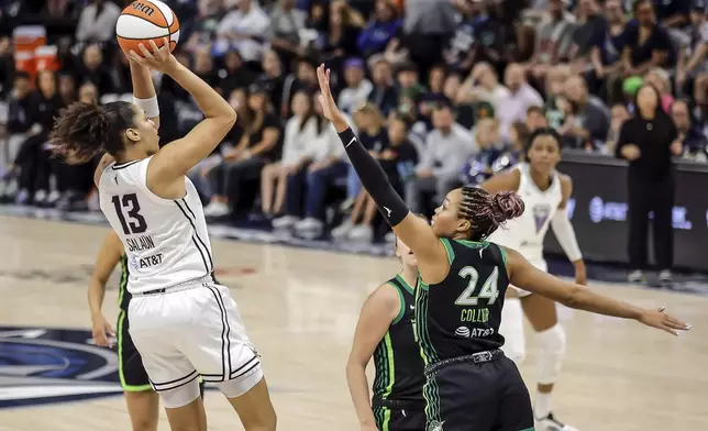 Janelle Salaun (13) shoots over Napheesa Collier (24) in the first half as the Golden State Valkyries played the Minnesota Lynx in Game 1 of the WNBA first round playoffs at Target Center in Minneapolis, Minn., on Sunday, Sept. 14, 2025. (Carlos Avila Gonzalez/San Francisco Chronicle via AP)