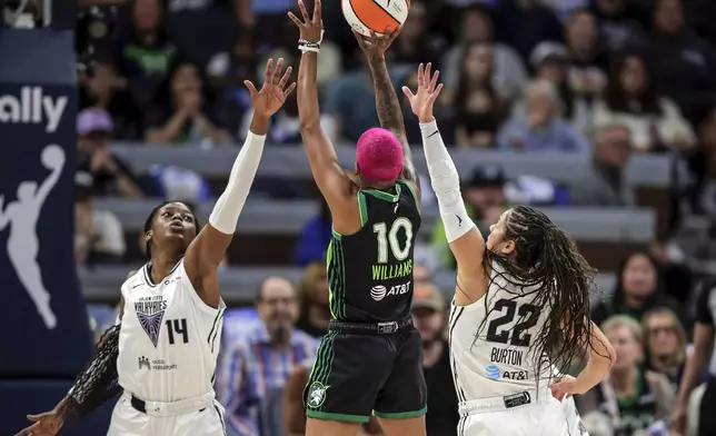 Veronica Burton (22) and Temi Fágbénlé (14) defend against Courtney Williams (10) in the first half as the Golden State Valkyries played the Minnesota Lynx in Game 1 of the WNBA first round playoffs at Target Center in Minneapolis, Minn., on Sunday, Sept. 14, 2025. (Carlos Avila Gonzalez/San Francisco Chronicle via AP)