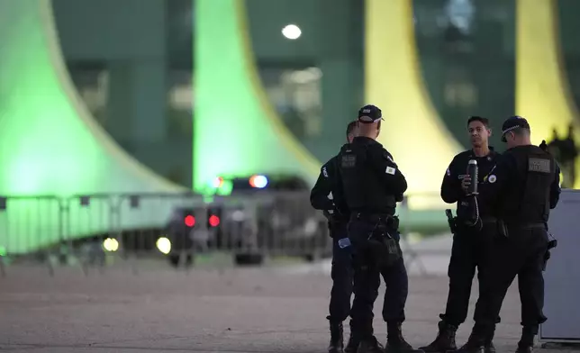Police stand guard in front of the Supreme Court, one day before the second part of former President Jair Bolsonaro's trial, in Brasilia, Brazil, Monday, Sept. 8, 2025. (AP Photo/Eraldo Peres)