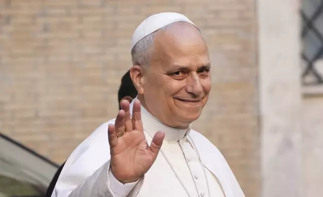 Pope Leo XIV waves as hr arrives at the St. Augustin Basilica in Rome, Monday, Sept. 1, 2025, to address his fellow Augustinians at the start of their global assembly. (AP Photo/Domenico Stinellis)