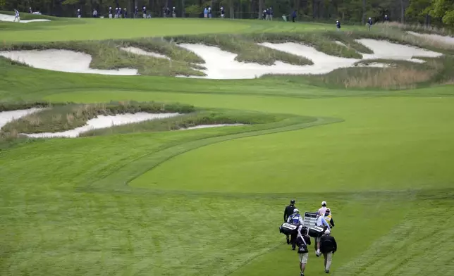 FILE - J.T. Poston, Jason Dufner and Jimmy Walker walk up the fourth fairway during the first round of the PGA Championship golf tournament, Thursday, May 16, 2019, at Bethpage Black in Farmingdale, N.Y. (AP Photo/Seth Wenig, File)