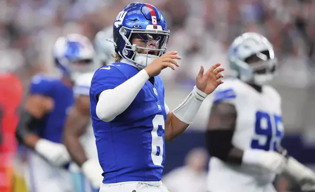 New York Giants' Jaxson Dart reacts after a call on the field in the second half of an NFL football game against the Dallas Cowboys Sunday, Sept. 14, 2025, in Arlington, Texas. (AP Photo/Julio Cortez)