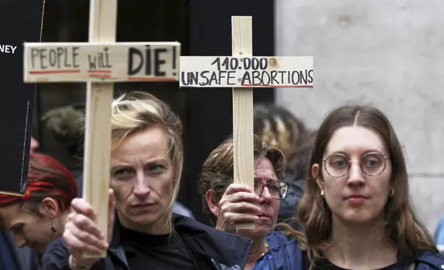 Participants from various women's rights organizations hold signs as they demonstrate regarding the destruction of family planning supplies stockpiled in Belgium, near the U.S. embassy in Brussels, Thursday, Sept. 18, 2025. (AP Photo/Omar Havana)
