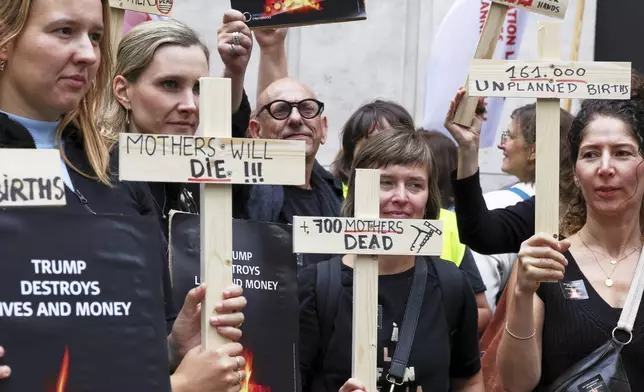 Participants from various women's rights organizations hold signs as they demonstrate regarding the destruction of family planning supplies stockpiled in Belgium, near the U.S. embassy in Brussels, Thursday, Sept. 18, 2025. (AP Photo/Omar Havana)