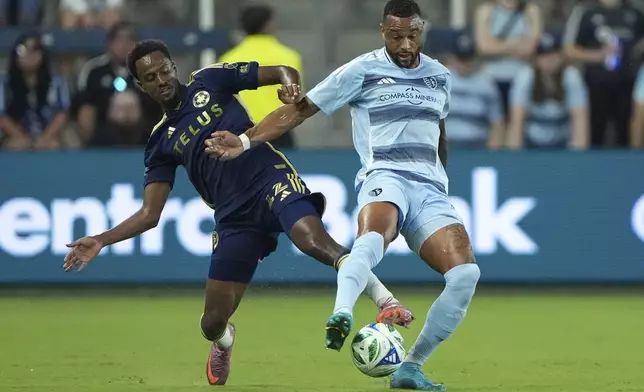Vancouver Whitecaps midfielder Ali Ahmed, left, tries to steal the ball from Sporting Kansas City defender Khiry Shelton, right, during the first half of an MLS soccer match Saturday, Sept. 20, 2025, in Kansas City, Kan. (AP Photo/Charlie Riedel)