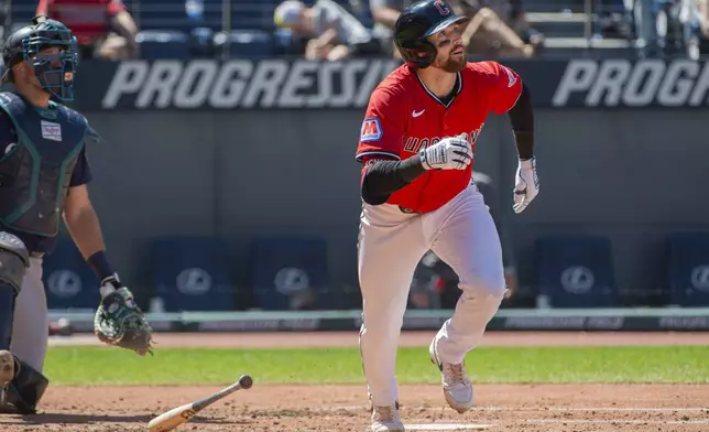 Cleveland Guardians' Daniel Schneemann watches his two-run home run off Seattle Mariners starting pitcher Bryce Miller along with catcher Cal Raleigh during the third inning of a baseball game, Sunday, Aug. 31, 2025, in Cleveland. (AP Photo/Phil Long)