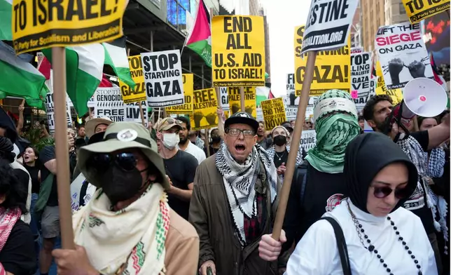 John Robinson demonstrates with others in Times Square during a pro-Palestinian demonstration, Friday, Sept. 26, 2025, in New York. (AP Photo/Angelina Katsanis)