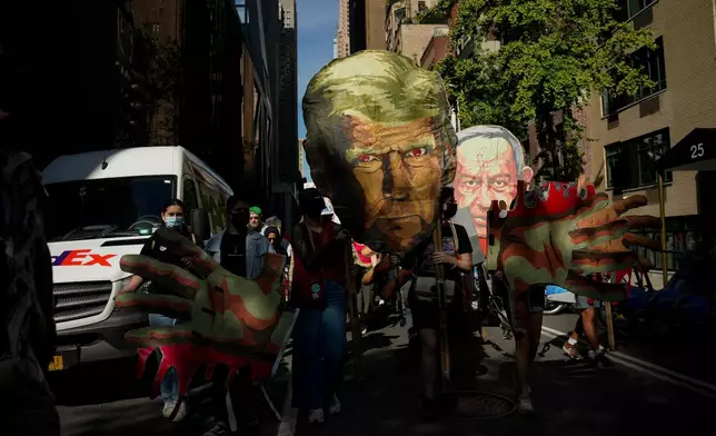 People march down 54th Street during a pro-Palestinian protest, Friday, Sept. 26, 2025, in New York. (AP Photo/Angelina Katsanis)