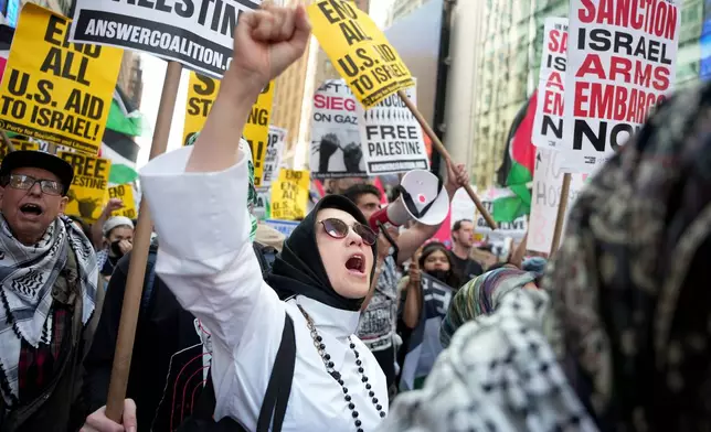 People demonstrate in Times Square during a pro-Palestinian protest, Friday, Sept. 26, 2025, in New York. (AP Photo/Angelina Katsanis)