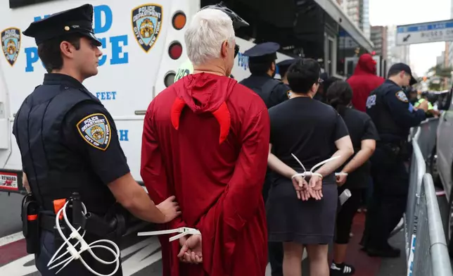 Protesters are arrested as they attempt to block traffic during the 80th session of the United Nations General Assembly, Tuesday, Sept. 23, 2025, in New York. (AP Photo/Heather Khalifa)