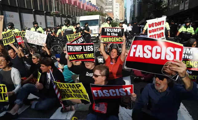 Protesters sit in a 42nd street intersection during the 80th session of the United Nations General Assembly in New York, Tuesday, Sept. 23, 2025. (AP Photo/Heather Khalifa)