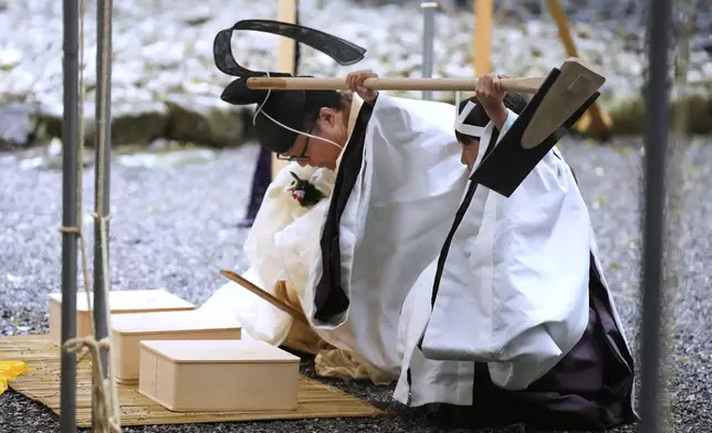A Shinto priest and a girl called "monoimi" participate in Yamaguchisai, a kickoff ceremony of Shikinen Sengu, concluding in 2033, at Toyoukedaijingu, also known as Geku, or the outer sanctuary, of the Jingu shrine complex in Ise, central Japan, Friday, May 2, 2025. (AP Photo/Hiro Komae)