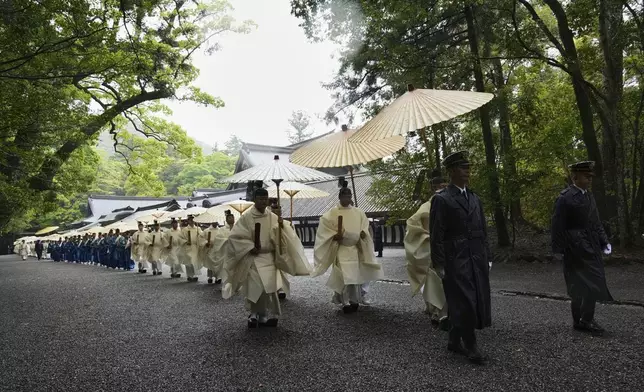 Priests and officials in the Shinto priesthood march during Yamaguchisai, a kickoff ceremony of the Shikinen Sengu ritual, which concludes in 2033, at Kotaijingu, also known as Naiku, or the inner sanctuary, of the Jingu shrine complex in Ise, central Japan, Friday, May 2, 2025. (AP Photo/Hiro Komae)