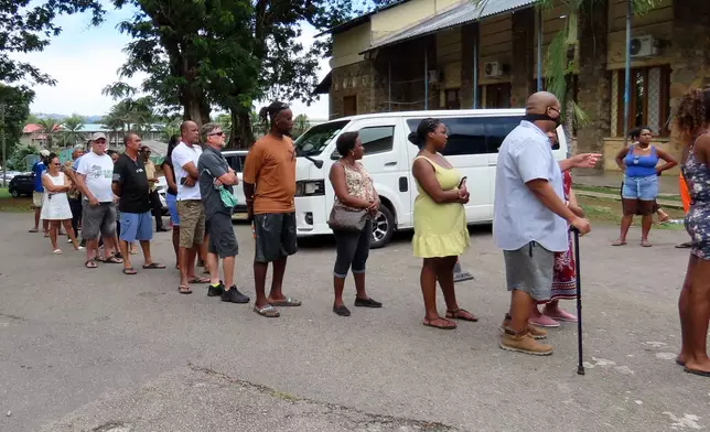 People line up to cast their votes at Bel Eau Primary School, Bel Air, Seychelles, on Saturday, Sep. 27, 2025. (AP Photo/Emilie Chetty)