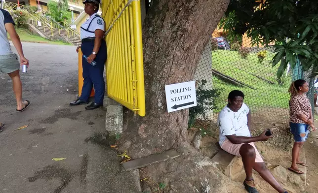 People wait to cast their votes at Bel Eau Primary School, Bel Air, Seychelles, on Saturday, Sep. 27, 2025. (AP Photo/Emilie Chetty)