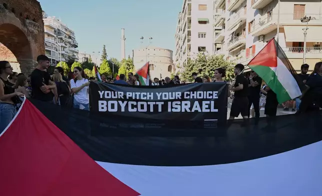 Pro-Palestinian protesters, most of them PAOK fans, gather ahead of a Europa League soccer match between PAOK and Israeli team Maccabi Tel Aviv in the port city of Thessaloniki, northern Greece, Wednesday, Sept. 24, 2025. (AP Photo/Giannis Papanikos)