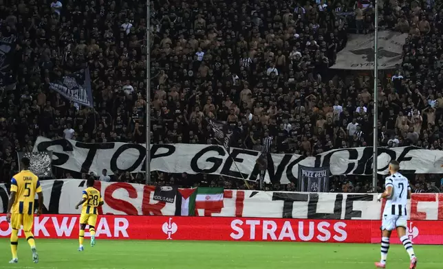PAOK's fans display a banner that reads "stop genocide" during the Europa League soccer match between PAOK and Maccabi Tel Aviv at Toumpa stadium, in Thessaloniki, Greece, Wednesday, Sept. 24, 2025. (AP Photo/Giannis Papanikos)