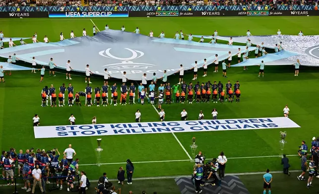 FILE - The players line up before the UEFA Super Cup soccer match between Paris Saint-Germain and Tottenham Hotspur in Udine, Italy, Wednesday, Aug. 13, 2025. (AP Photo/Denes Erdos, File)