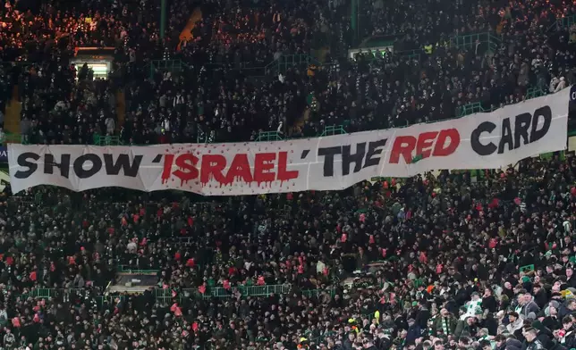 FILE - Celtic fans lift a protest banner about Israel during the Champions League playoff first leg soccer match between Glasgow Celtic and Bayern Munich at the Celtic Park Stadium in Glasgow, Scotland, Wednesday, Feb. 12, 2025. (AP Photo/Scott Heppell, File)