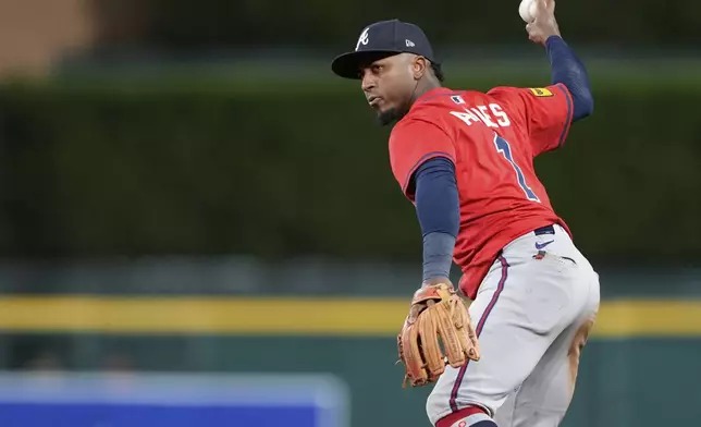 Atlanta Braves second baseman Ozzie Albies prepares to throw out Detroit Tigers' Parker Meadows at first base during the sixth inning of a baseball game, Friday, Sept. 19, 2025, in Detroit. (AP Photo/Ryan Sun)