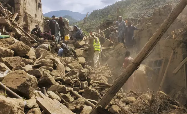 Civil defense workers, locals, and army soldiers clear rubble as they search for survivors after a powerful 6.0-magnitude earthquake struck eastern Afghanistan on Sunday, killing many people and destroying villages, in Mazar Dara, Kunar province, Afghanistan, Tuesday, Sept. 2, 2025.(AP Photo/Hedayat Shah)