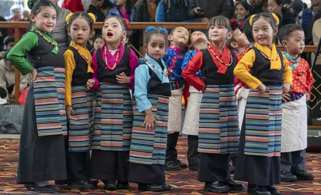 Exiled Tibetan children wait to perform a dance during an event to mark the 65th anniversary of the formation of the parliament-in-exile as Tibetan Democracy Day at the Tsuglakhang temple in Dharamshala, India, Tuesday, Sept. 2, 2025. (AP Photo/Ashwini Bhatia)