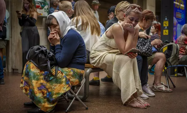 People rest in a metro station, being used as a bomb shelter, during a Russian attack in Kyiv, Ukraine, Tuesday, Sept. 2, 2025. (AP Photo/Dan Bashakov)